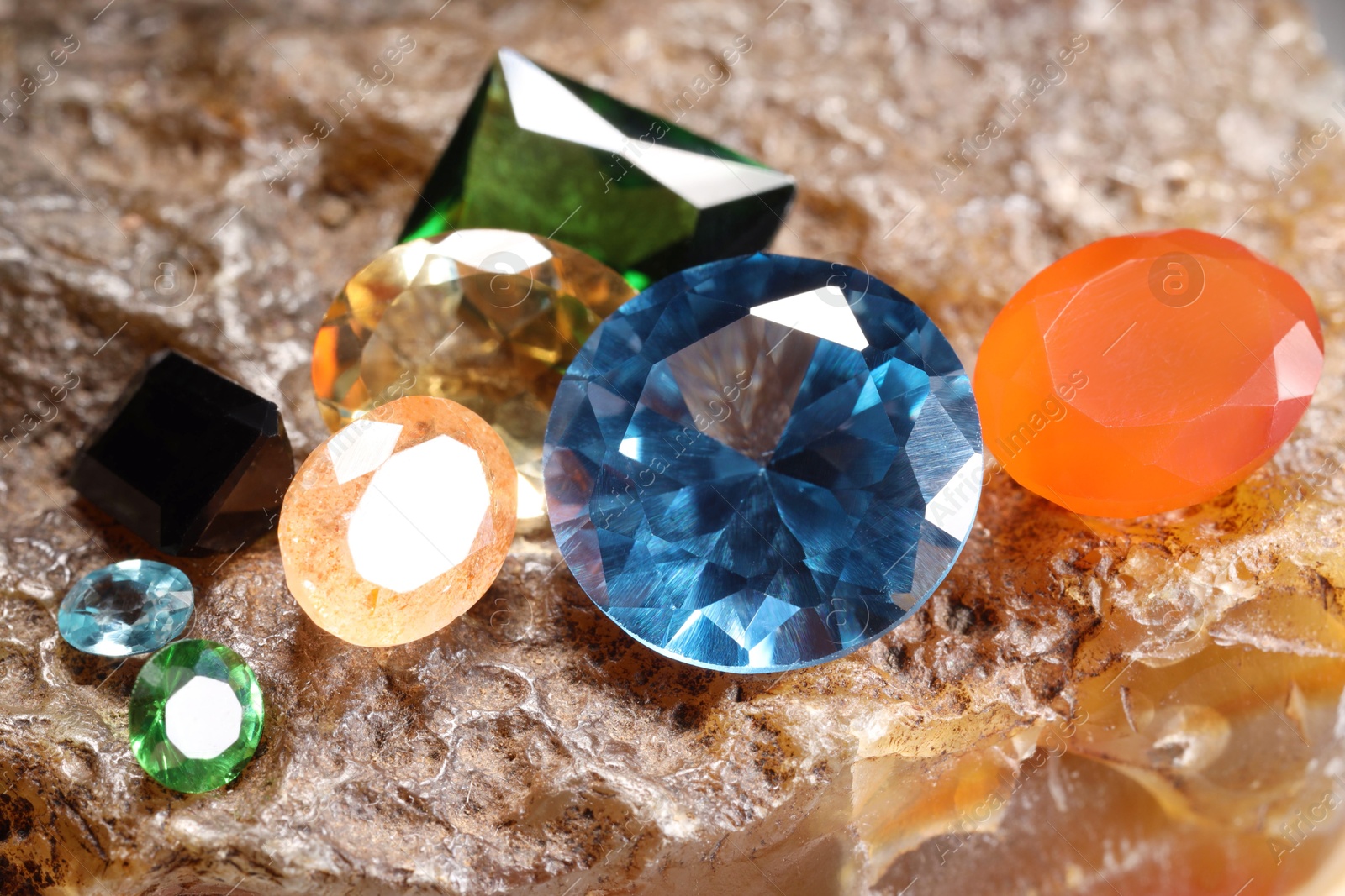 Photo of Beautiful shiny colorful gemstones on rock, closeup