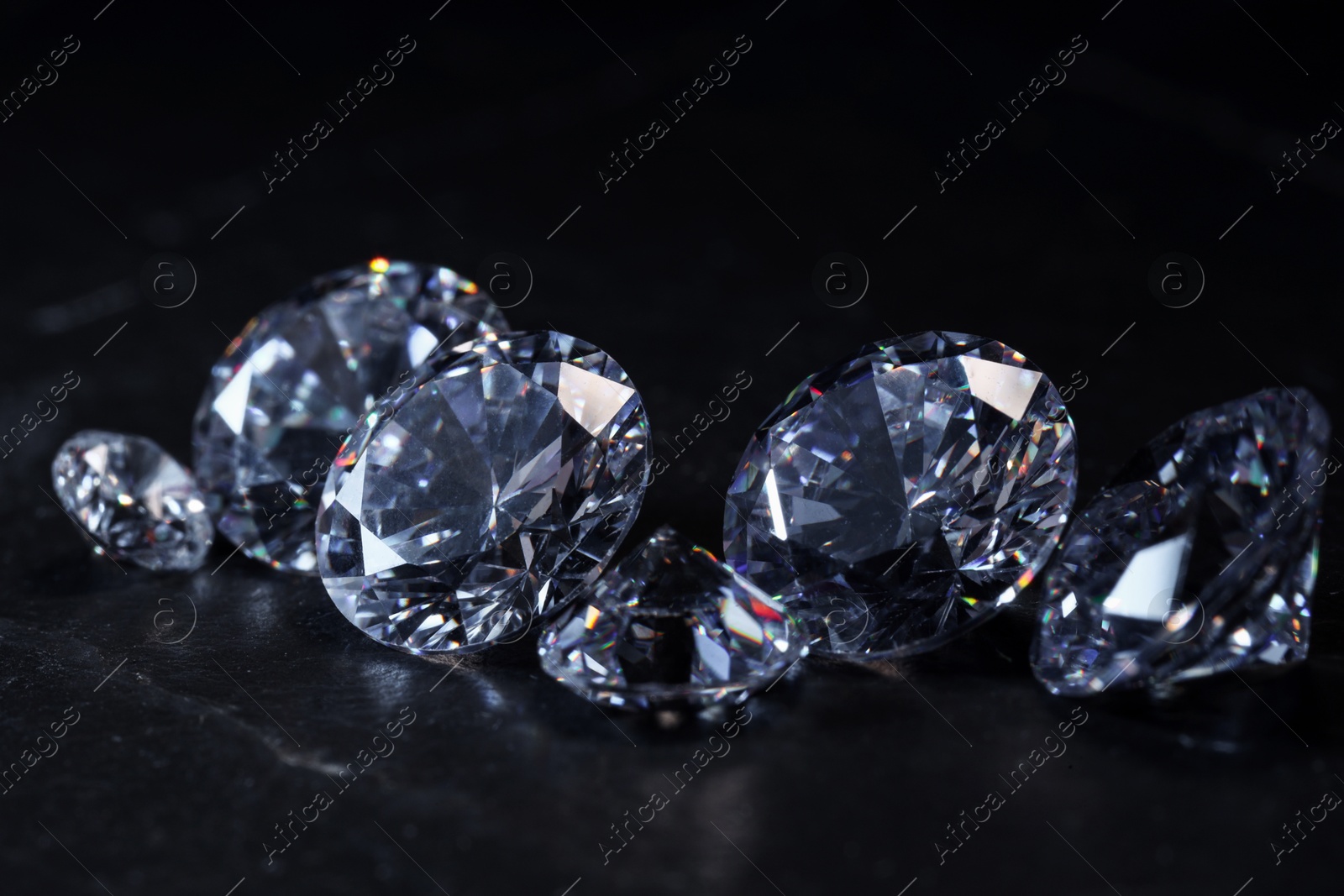 Photo of Beautiful shiny gemstones on black background, closeup