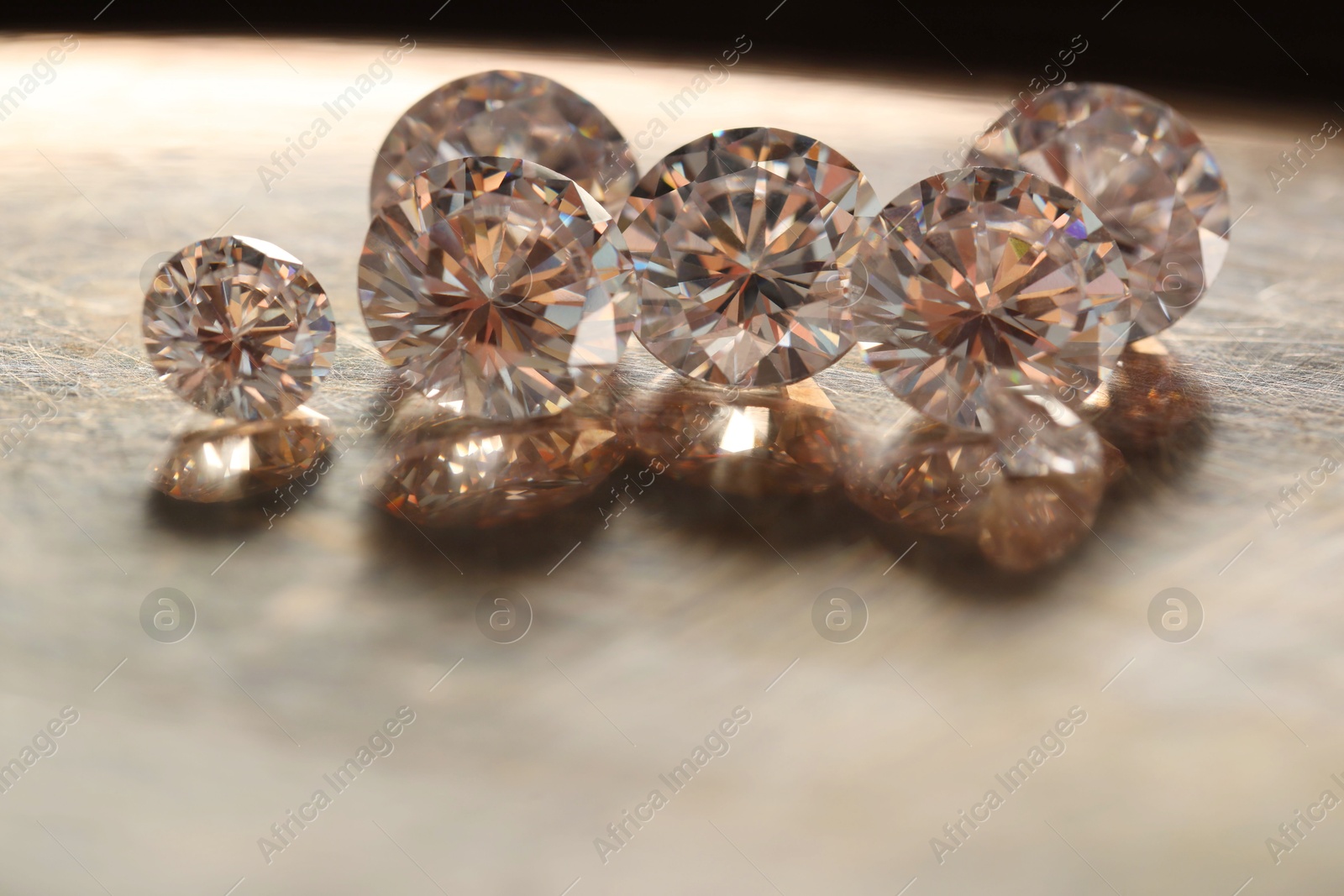 Photo of Beautiful shiny gemstones on metal tray, closeup