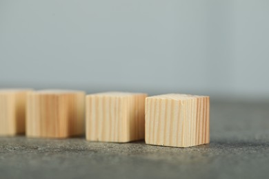 Photo of Many wooden cubes on grey table, closeup