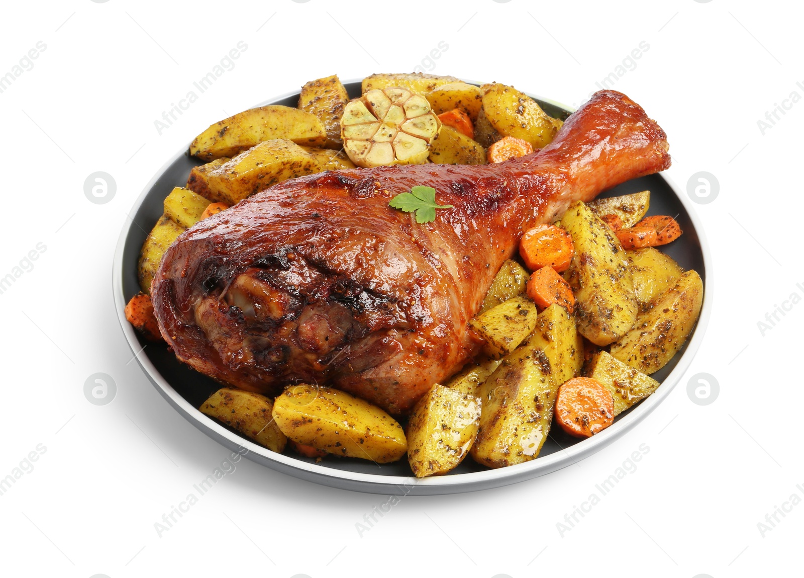 Photo of Baked turkey drumstick and vegetables isolated on white