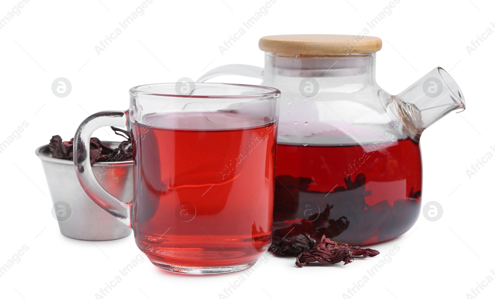 Photo of Delicious hibiscus tea in glass cup, teapot and dry roselle sepals isolated on white