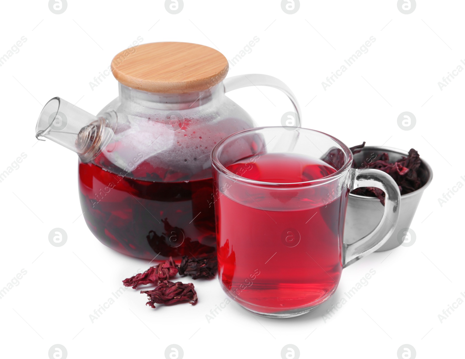 Photo of Delicious hibiscus tea in glass cup, teapot and dry roselle sepals isolated on white