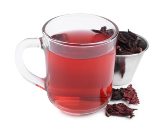 Photo of Delicious hibiscus tea in glass cup and dry roselle sepals isolated on white