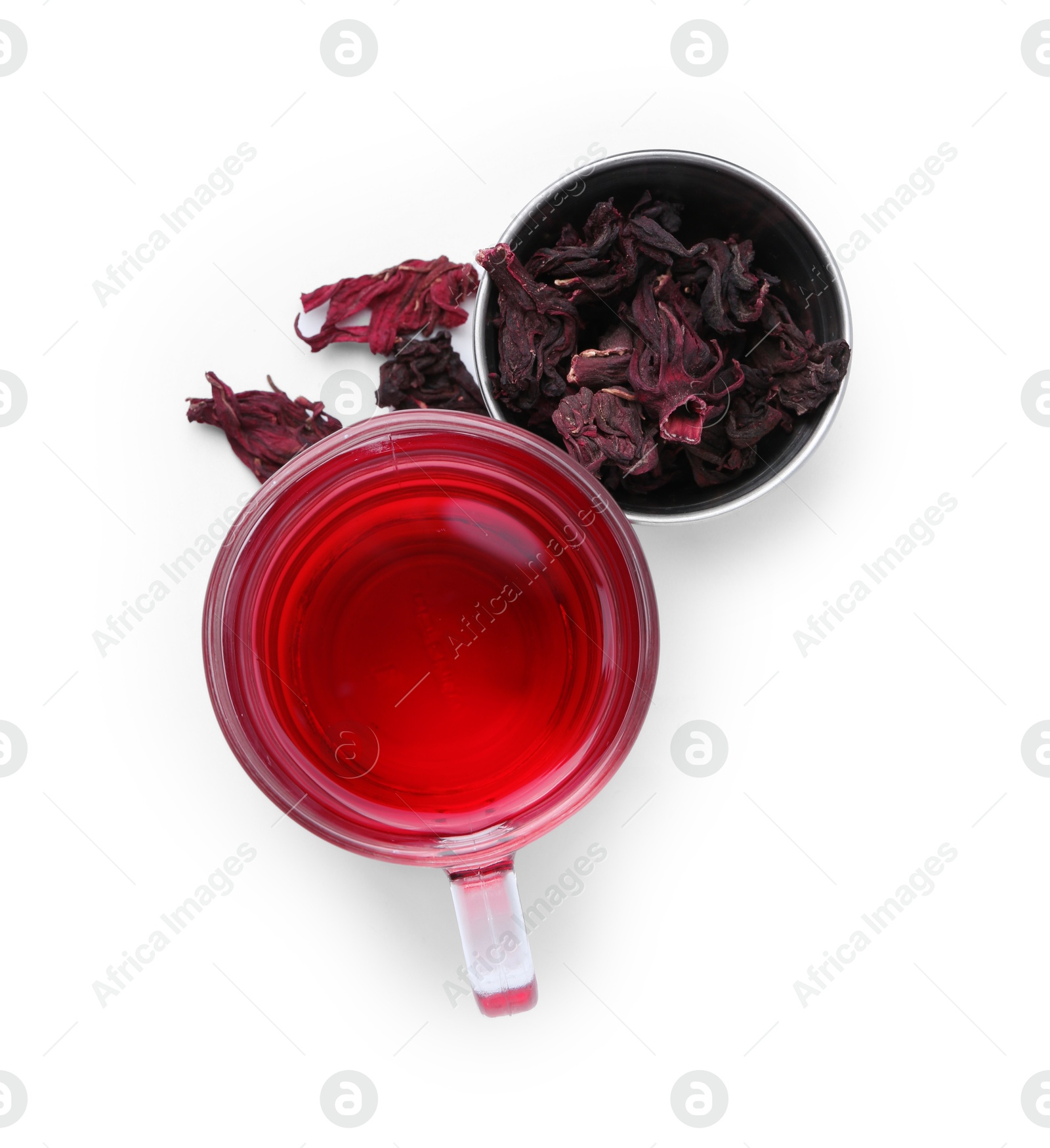 Photo of Delicious hibiscus tea in glass cup and dry roselle sepals isolated on white, top view