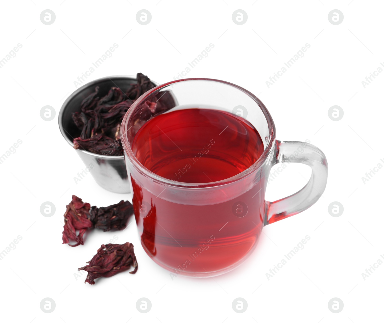 Photo of Delicious hibiscus tea in glass cup and dry roselle sepals isolated on white