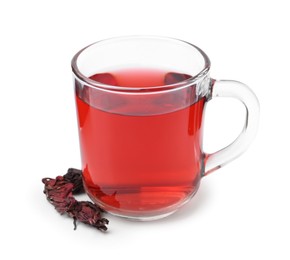 Photo of Delicious hibiscus tea in glass cup and dry roselle sepals isolated on white