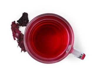 Photo of Delicious hibiscus tea in glass cup and dry roselle sepals isolated on white, top view