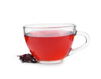 Photo of Delicious hibiscus tea in glass cup and dry roselle sepals isolated on white