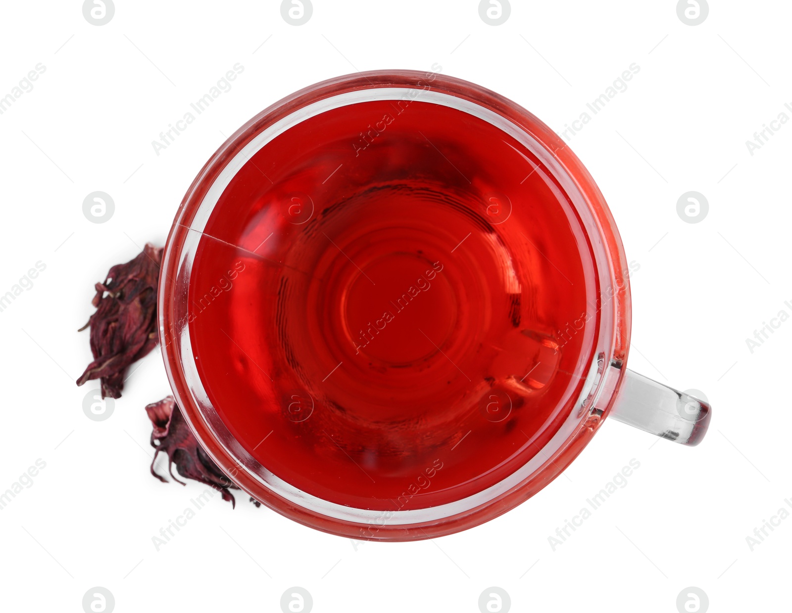 Photo of Delicious hibiscus tea in glass cup and dry roselle sepals isolated on white, top view