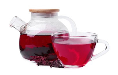 Photo of Delicious hibiscus tea in glass cup, teapot and dry roselle sepals isolated on white