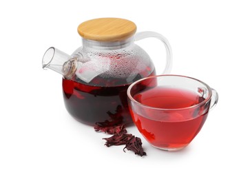 Photo of Delicious hibiscus tea in glass cup, teapot and dry roselle sepals isolated on white