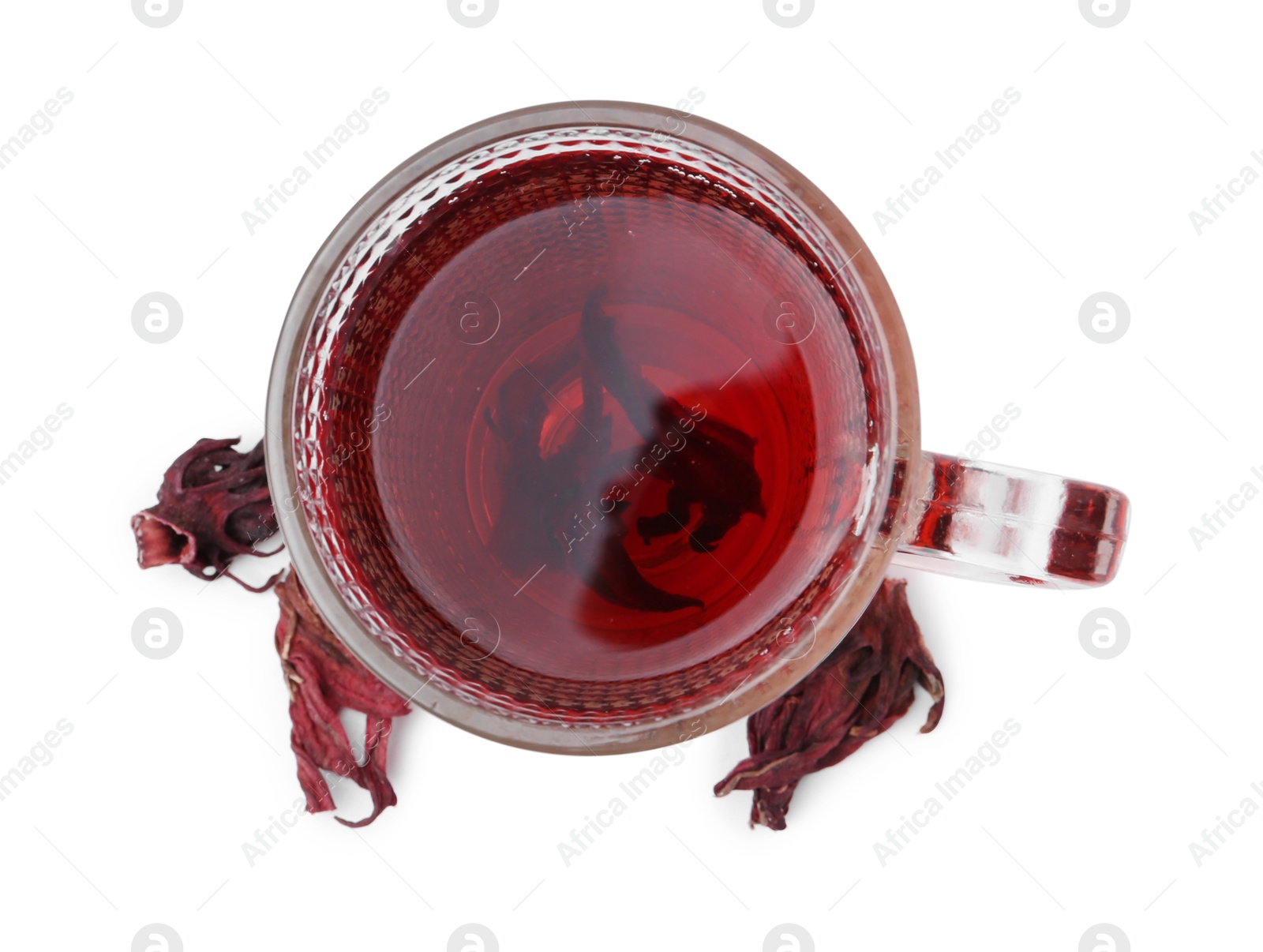 Photo of Delicious hibiscus tea in glass cup and dry roselle sepals isolated on white, top view