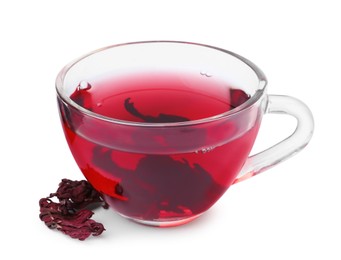 Photo of Delicious hibiscus tea in glass cup and dry roselle sepals isolated on white