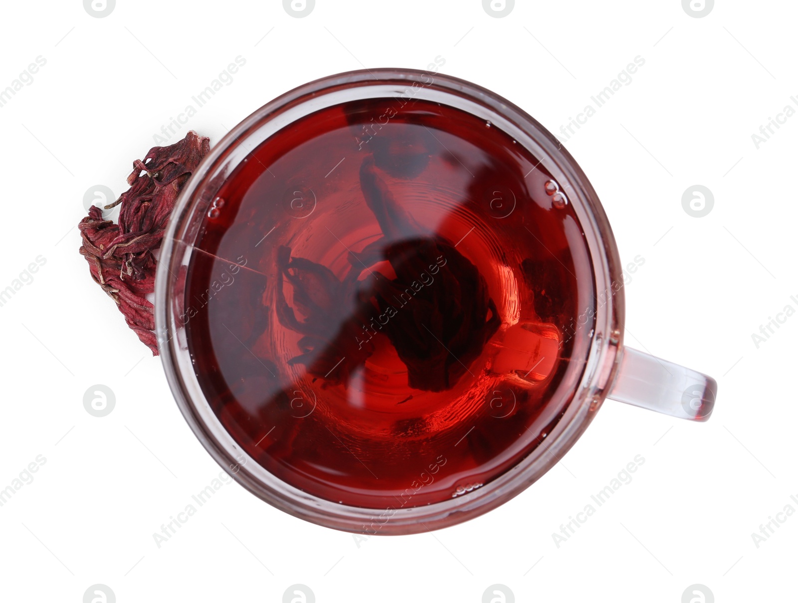 Photo of Delicious hibiscus tea in glass cup and dry roselle sepals isolated on white, top view