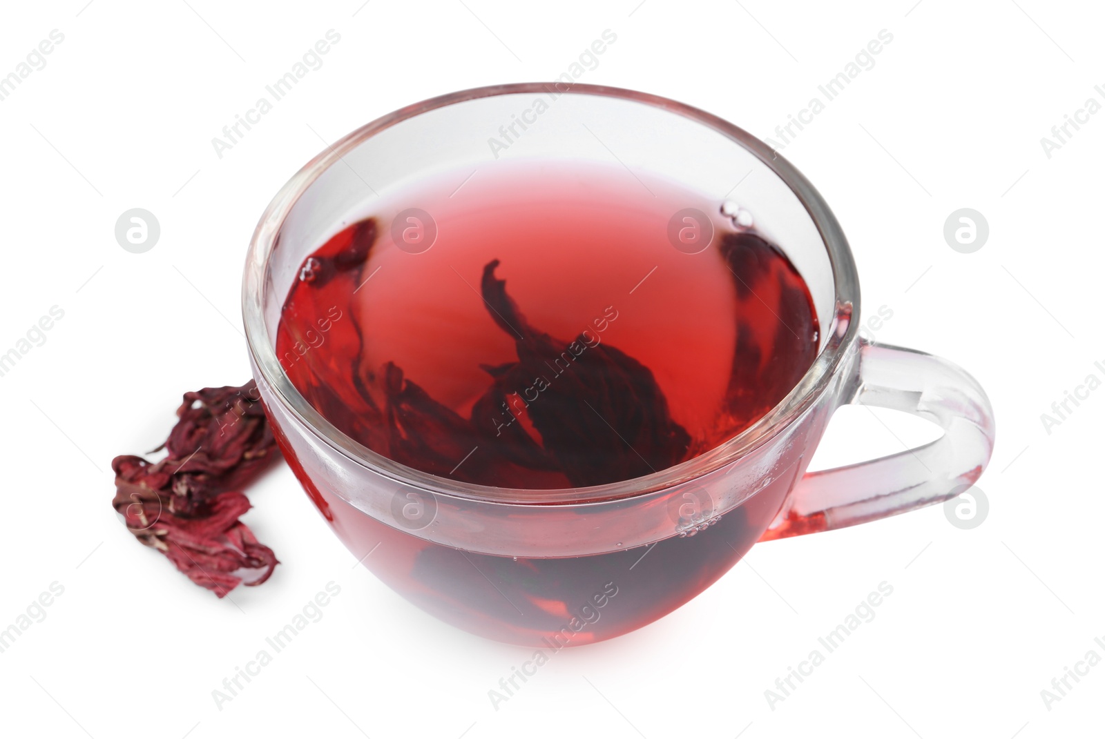 Photo of Delicious hibiscus tea in glass cup and dry roselle sepals isolated on white