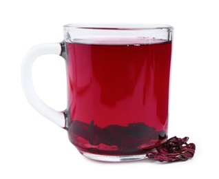 Photo of Delicious hibiscus tea in glass cup and dry roselle sepals isolated on white