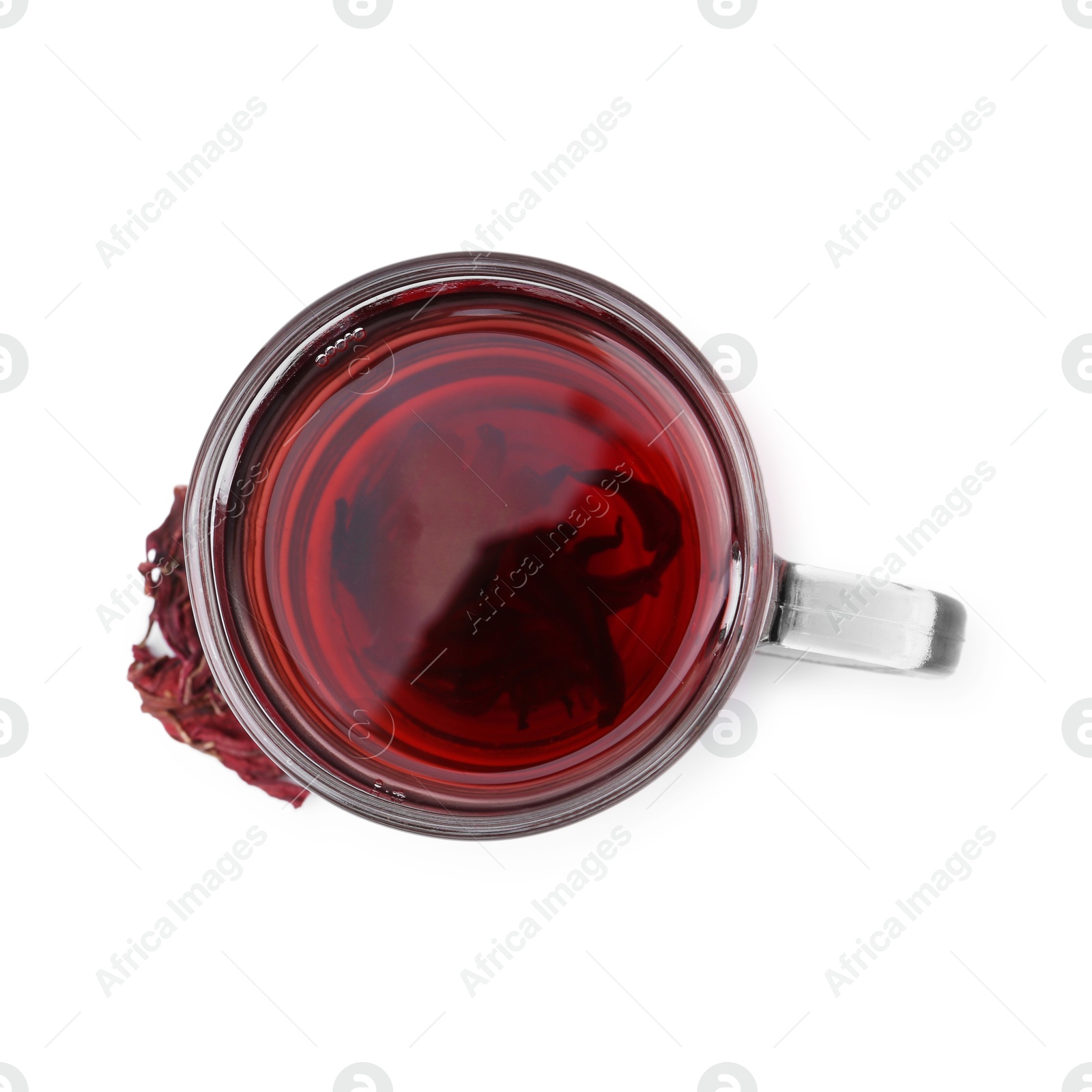 Photo of Delicious hibiscus tea in glass cup and dry roselle sepals isolated on white, top view