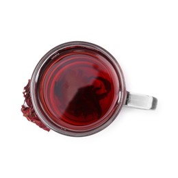 Photo of Delicious hibiscus tea in glass cup and dry roselle sepals isolated on white, top view