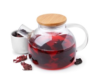 Photo of Delicious hibiscus tea in glass teapot and dry roselle sepals isolated on white