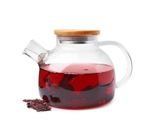 Photo of Delicious hibiscus tea in glass teapot and dry roselle sepals isolated on white