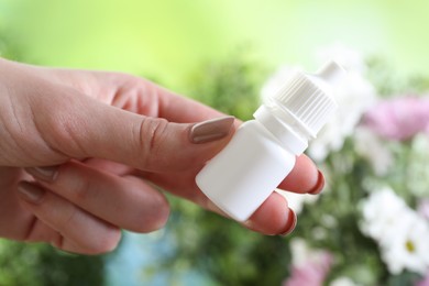 Photo of Allergy treatment. Woman with medical drops on blurred background, closeup