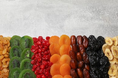 Photo of Different dried fruits on grey table, top view. Space for text