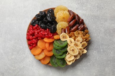 Photo of Different dried fruits on grey table, top view