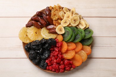 Photo of Different dried fruits on white wooden table, top view