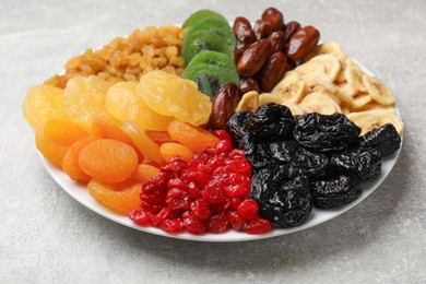 Photo of Mix of different dried fruits on grey table, closeup