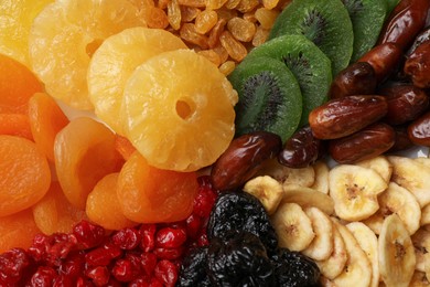 Photo of Mix of different dried fruits as background, top view