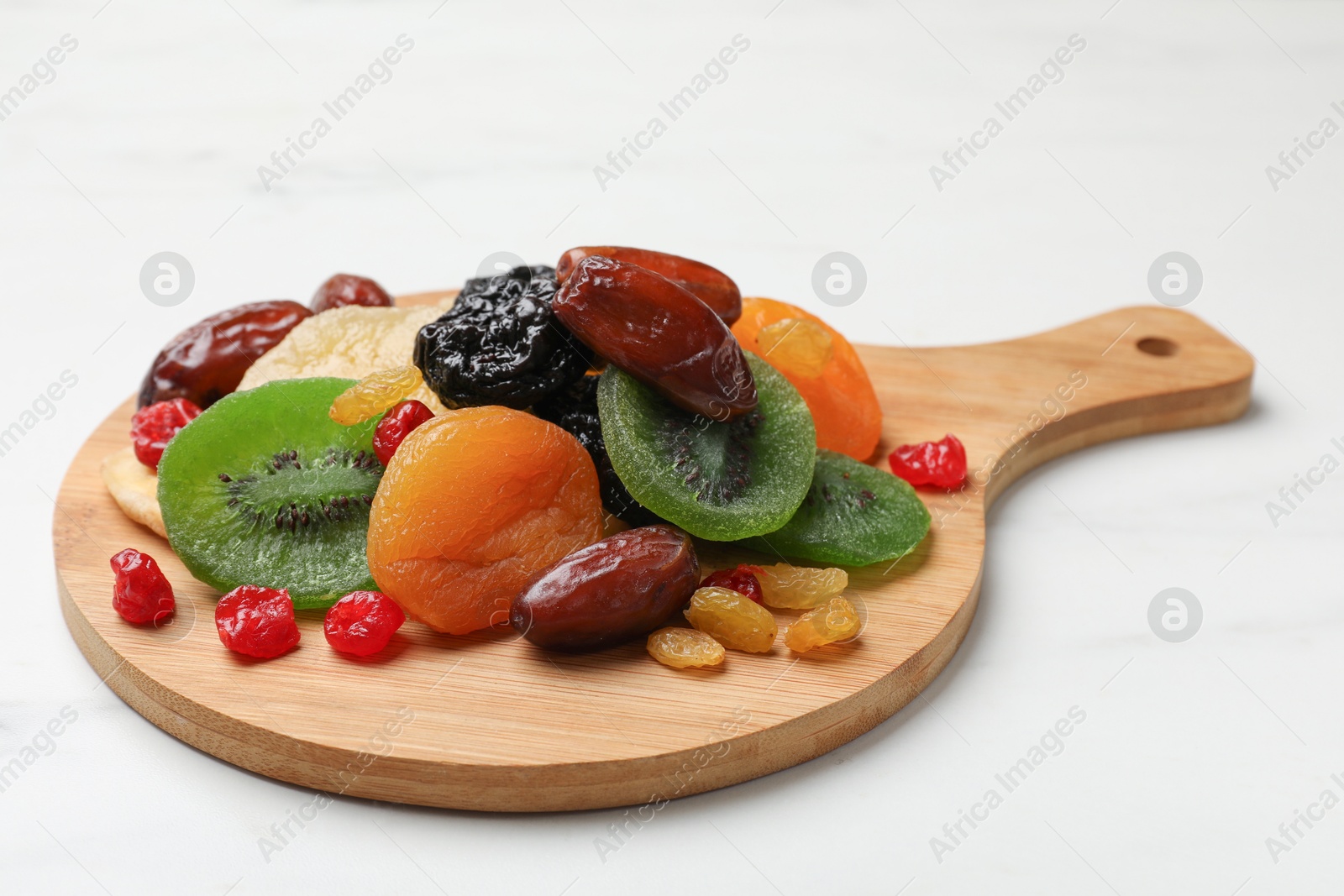 Photo of Mix of different dried fruits on white background, closeup