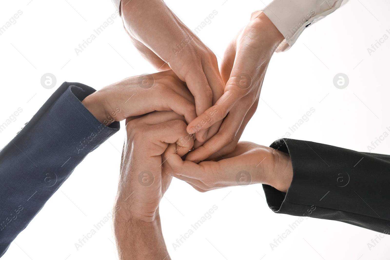 Photo of Teamwork. Group of people joining hands together indoors, bottom view