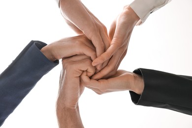 Teamwork. Group of people joining hands together indoors, bottom view