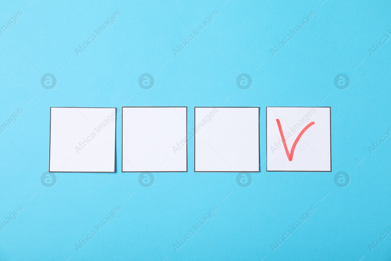 Photo of One checkbox with tick mark among others on light blue background, flat lay