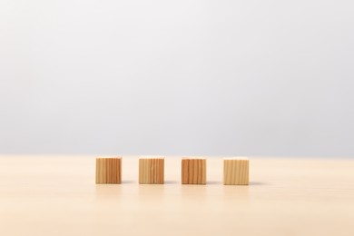 Photo of Many wooden cubes on table, space for text