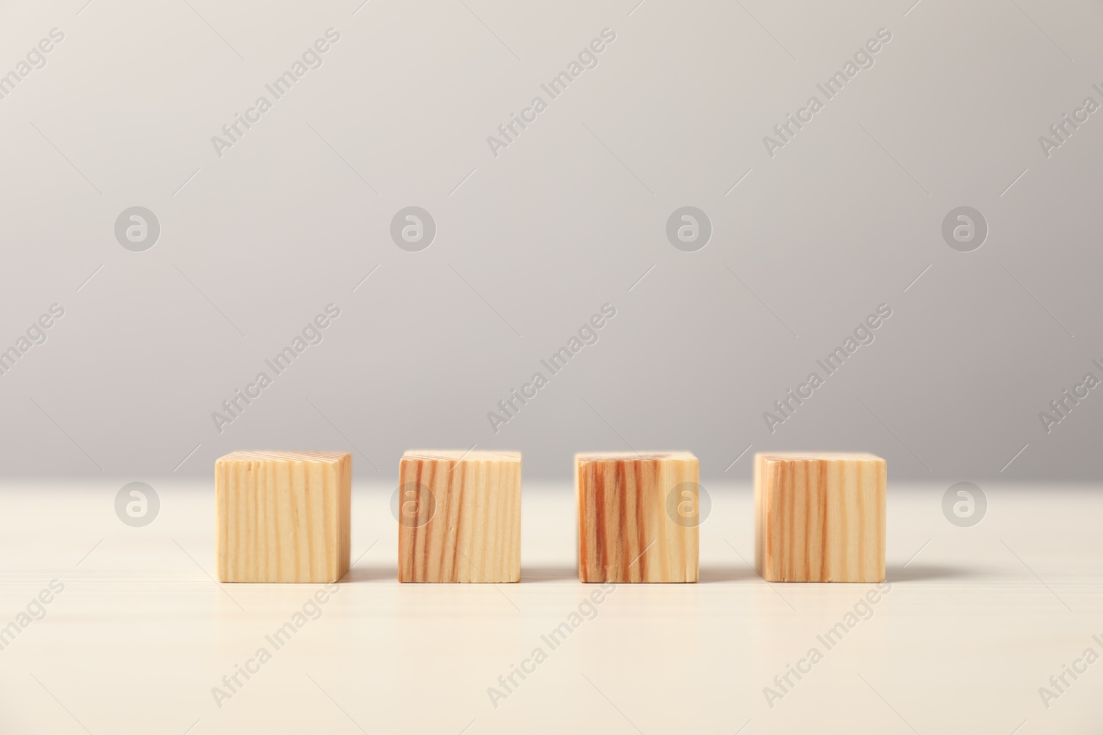 Photo of Many wooden cubes on light table, space for text