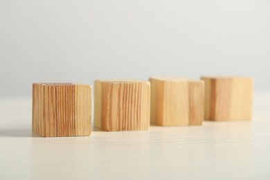 Photo of Many wooden cubes on light table, closeup