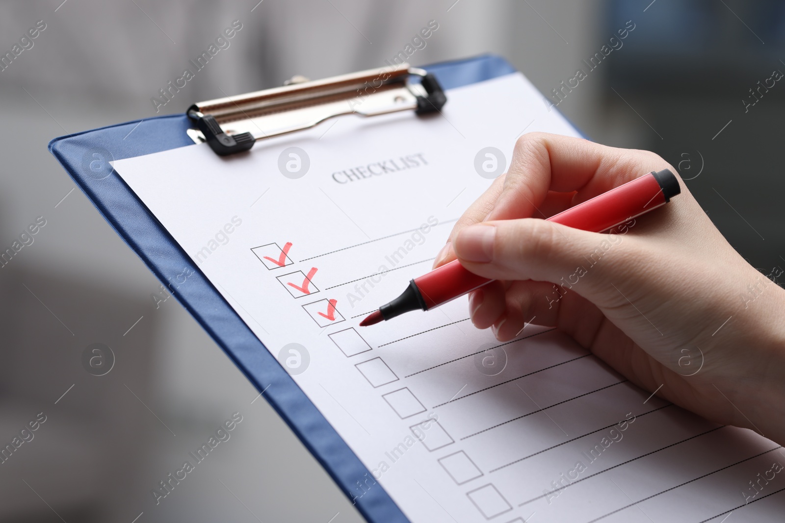 Photo of Woman filling Checklist on blurred background, closeup