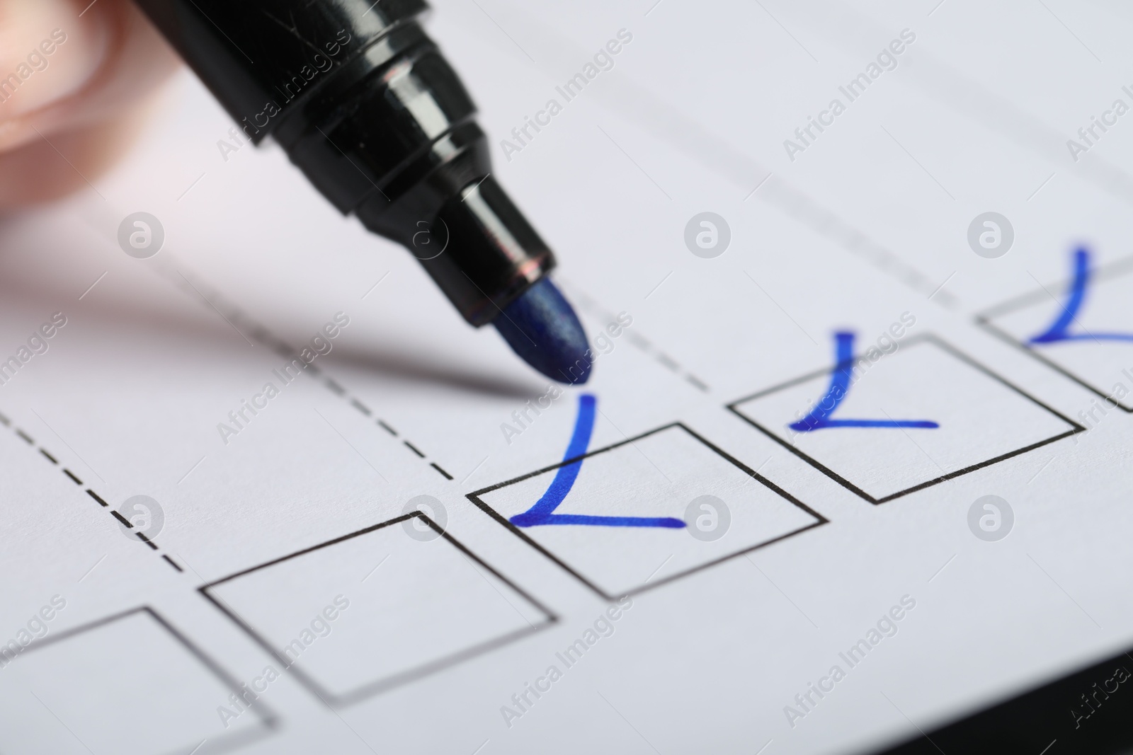 Photo of Woman checking box of paper form, closeup