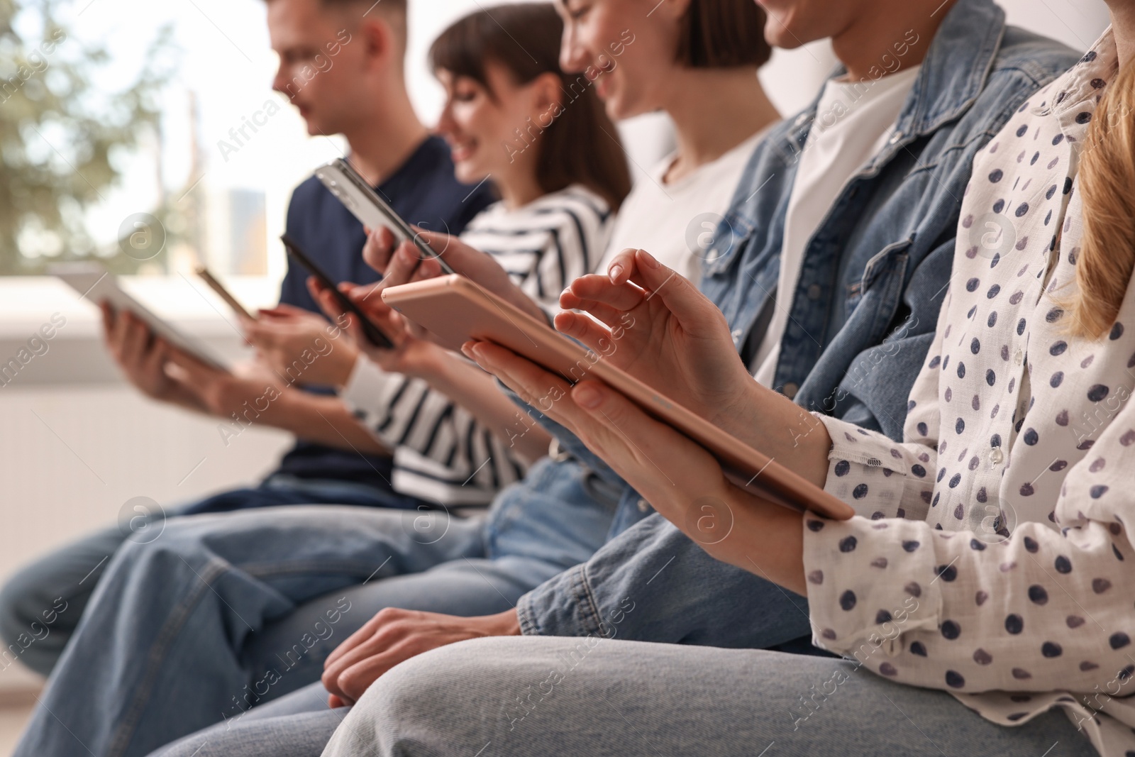 Photo of Group of people using different gadgets indoors, closeup. Modern technology