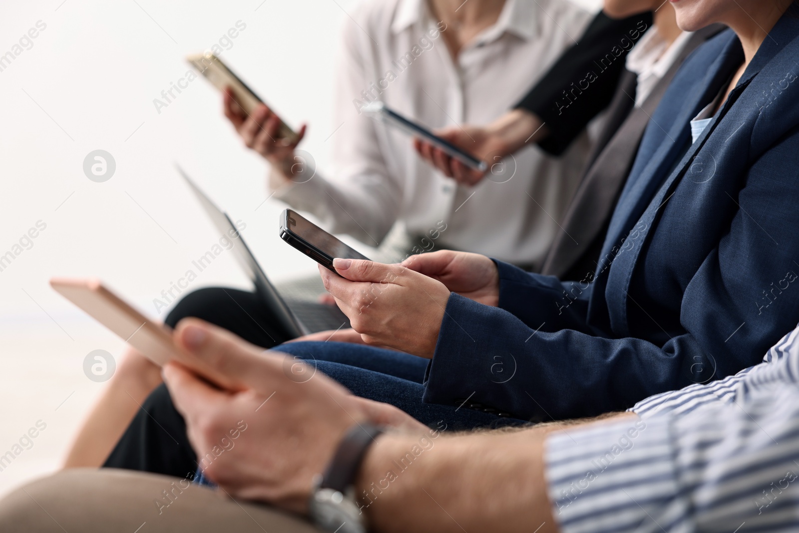 Photo of Group of people using different gadgets indoors, closeup. Modern technology