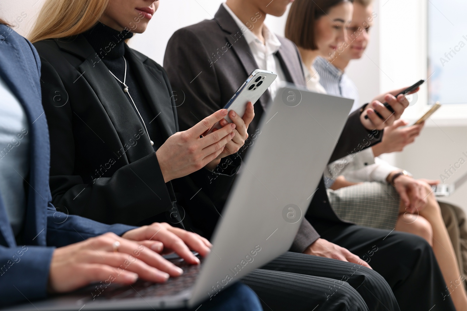 Photo of Group of people using different gadgets indoors, closeup. Modern technology