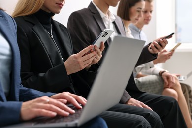 Photo of Group of people using different gadgets indoors, closeup. Modern technology