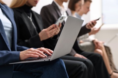 Photo of Group of people using different gadgets indoors, closeup. Modern technology