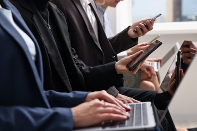 Photo of Group of people using different gadgets indoors, closeup. Modern technology