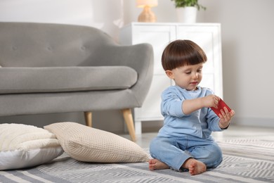 Photo of Little boy playing with matchbox at home. Child in danger