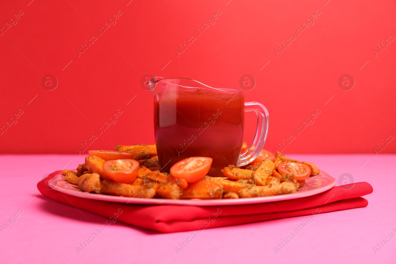 Photo of Tasty ketchup, tomatoes and fried carrots on color background