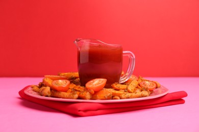 Photo of Tasty ketchup, tomatoes and fried carrots on color background