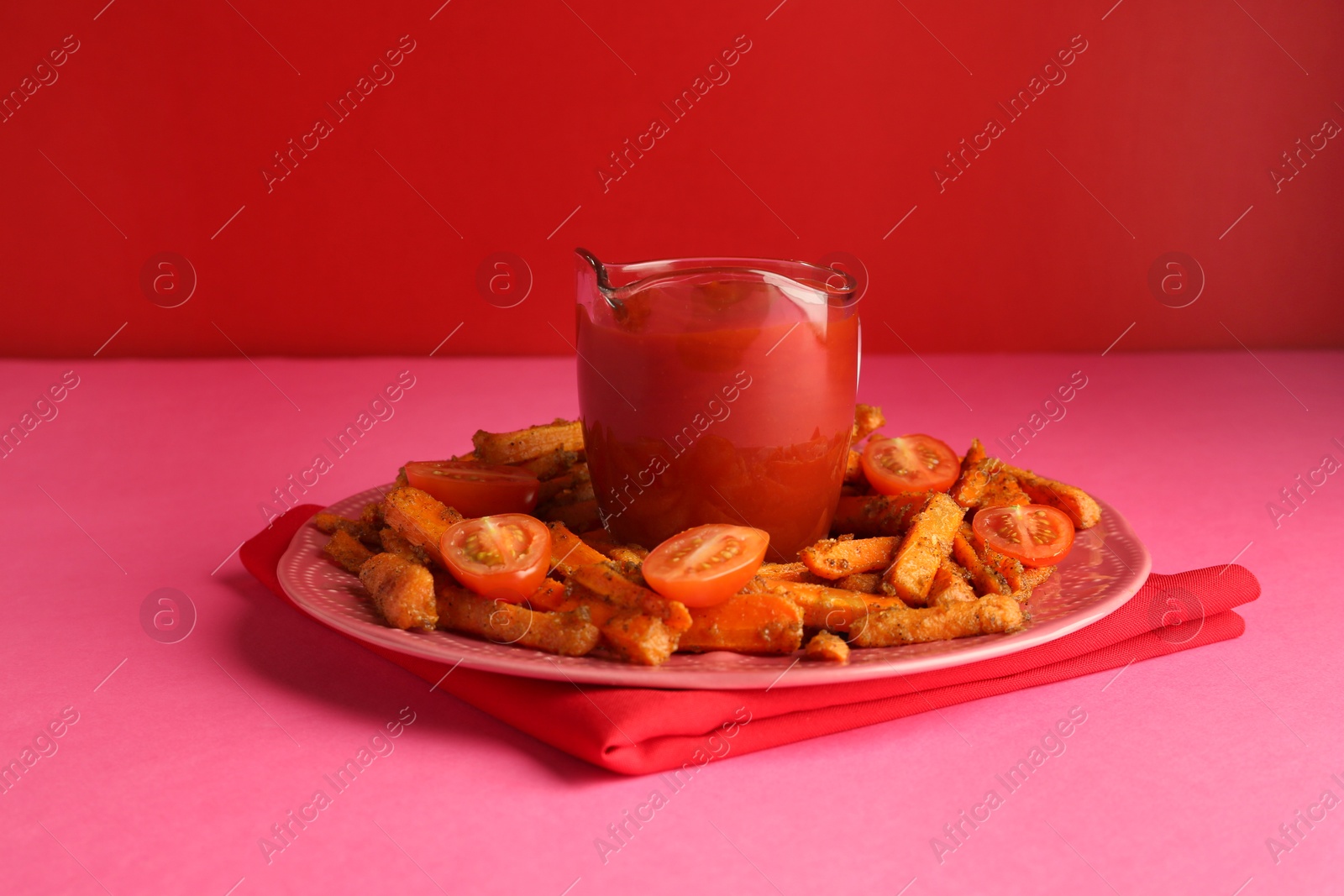 Photo of Tasty ketchup, tomatoes and fried carrots on color background